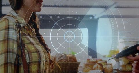 Woman shopping with card at bakery featuring futuristic overlay
