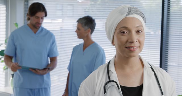 Smiling Doctor with Colleagues in Medical Clinic - Download Free Stock Images Pikwizard.com