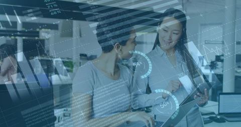 Business Professionals Analyzing Data on Tablet in Modern Office