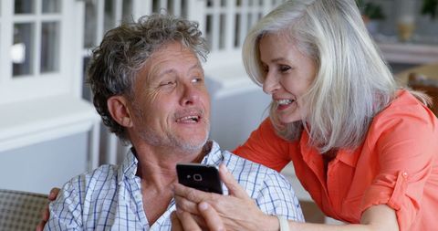 Happy Senior Couple Sharing Intimate Moment with Smartphone - Download Free Stock Images Pikwizard.com