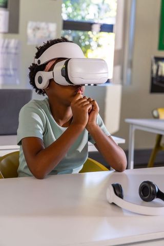 African american student exploring virtual reality in classroom for immersive learning