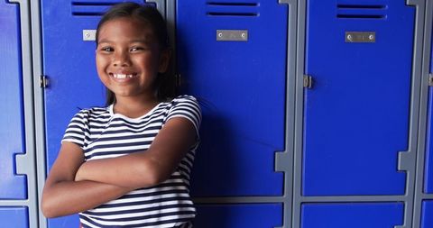 Confident Girl Smiling by School Lockers - Download Free Stock Images Pikwizard.com