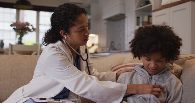 Female doctor using stethoscope to check young child's health in home environment, suggesting a nurturing and personalized healthcare approach. Articles about home healthcare, pediatric care, and medical visits. Useful for promotion of healthcare services, patient care, and family healthcare.