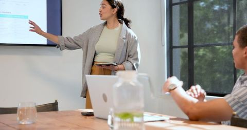 Confident Businesswoman Leads Successful Office Presentation