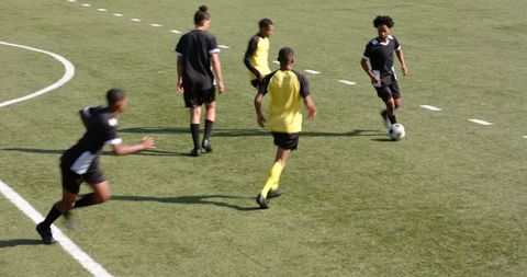 Youth Soccer Players Practicing on Green Field