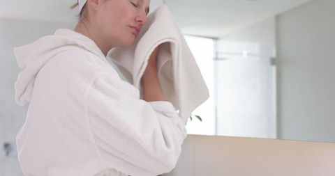Woman Relaxing with Towel in Modern Bathroom Setting
