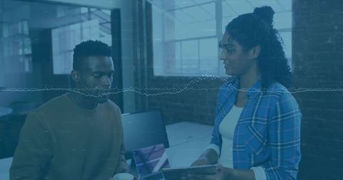 Coworking professionals discussing project in modern office