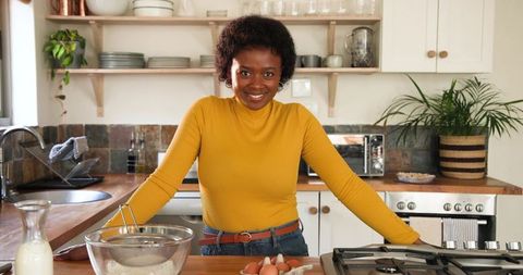 Smiling Woman Baking in a Rustic Kitchen Environment