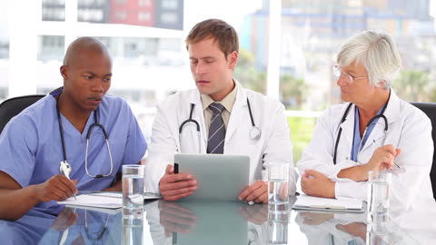 Diverse Medical Team Collaborating with Technology in Modern Office