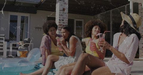 Friends Enjoying Refreshing Cocktails by Poolside in Summer