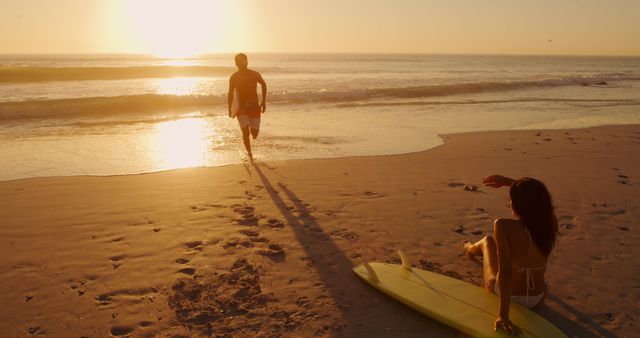 Couple Enjoying Sunset on Beach with Surfboard - Download Free Stock Images Pikwizard.com