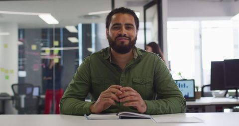 Confident Businessman Conducting Video Call at Modern Office Desk