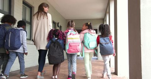 Teacher with Children Walking in School Corridor Outdoor Exploration