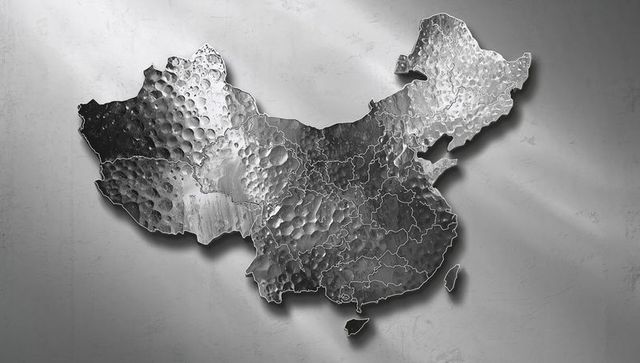 Hammered metal relief map of china on textured gray wall