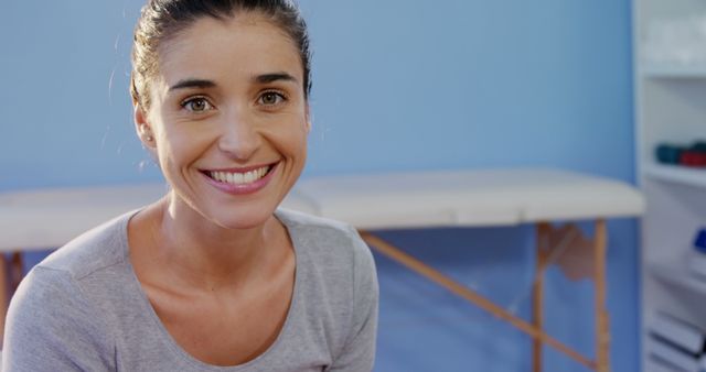 Smiling Woman in Health Clinic with Blue Background - Download Free Stock Images Pikwizard.com