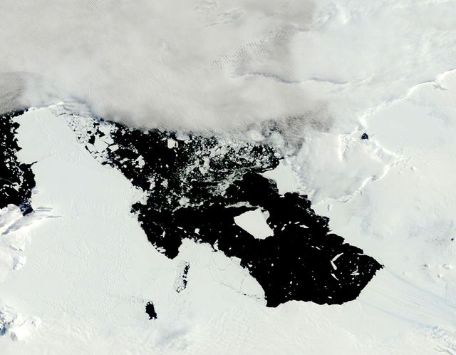 The voyage of Iceberg B-31 continued in January, 2014 as the giant iceberg drifted over the frigid waters of Pine Island Bay and widened the gap between the newly-calved iceberg and the “mother” glacier.  Between November 9 and 11, 20143 a giant crack in the Pine Island Glacier gave completely away, liberating Iceberg B-31 from the end of the glacial tongue. The new iceberg was estimated to be 35 km by 20 km (21 mi by 12 mi) in size – or roughly the size of Singapore.  On January 5, 2014 the Moderate Resolution Imaging Spectroradiometer (MODIS) aboard NASA’s Terra satellite captured this true-color image of B-31 floating in the center of Pine Island Bay on an approach to the Amundsen Sea. Pine Island Glacier can be seen on the upper right coast of the bay, and is marked by parallel lines in the ice. According to measurements reported by the National U.S. Ice Center, on January 10, B-31 was maintaining its size, and was located at 74°24'S and 104°33'W.  Credit: NASA/GSFC/Jeff Schmaltz/MODIS Land Rapid Response Team  <b><a href="http://www.nasa.gov/audience/formedia/features/MP_Photo_Guidelines.html" rel="nofollow">NASA image use policy.</a></b>  <b><a href="http://www.nasa.gov/centers/goddard/home/index.html" rel="nofollow">NASA Goddard Space Flight Center</a></b> enables NASA’s mission through four scientific endeavors: Earth Science, Heliophysics, Solar System Exploration, and Astrophysics. Goddard plays a leading role in NASA’s accomplishments by contributing compelling scientific knowledge to advance the Agency’s mission.  <b>Follow us on <a href="http://twitter.com/NASA_GoddardPix" rel="nofollow">Twitter</a></b>  <b>Like us on <a href="http://www.facebook.com/pages/Greenbelt-MD/NASA-Goddard/395013845897?ref=tsd" rel="nofollow">Facebook</a></b>  <b>Find us on <a href="http://instagrid.me/nasagoddard/?vm=grid" rel="nofollow">Instagram</a></b>