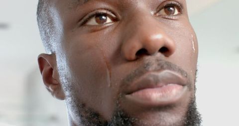 Expressive portrait of man crying reflecting vulnerability