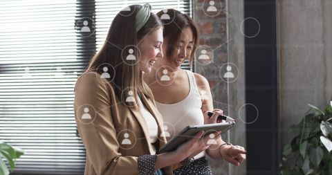 Diverse business colleagues analyzing digital data in modern office