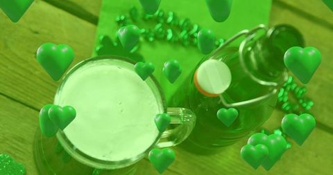 St patrick's day green beer mug with swing-top bottle and shamrock confetti on wood