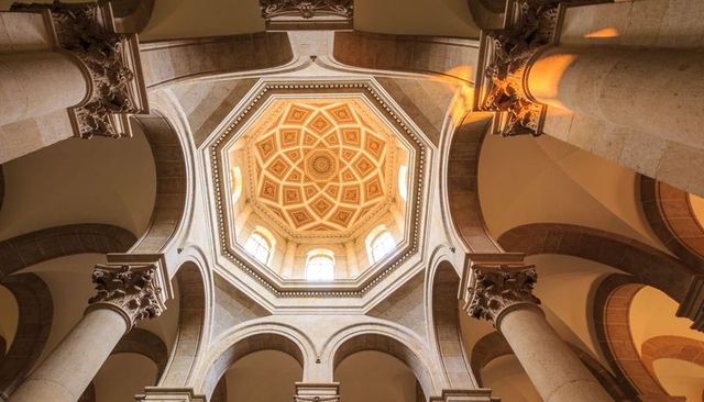 Octagonal coffered dome with lantern and corinthian columns in classical basilica interior