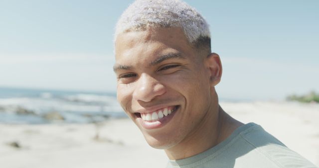 Smiling Man with Dyed Hair Enjoying Sunny Beach Day - Download Free Stock Images Pikwizard.com