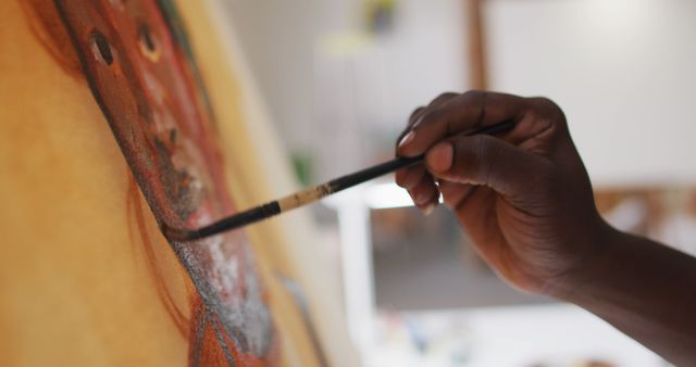 This image shows a close-up of an artist painting on a canvas, highlighting the brush and detailed strokes. It can be used for creative projects, art tutorials, or websites about fine arts and hobbies.
