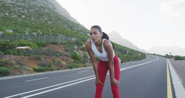 Female Runner Taking a Break on Mountain Road - Download Free Stock Images Pikwizard.com