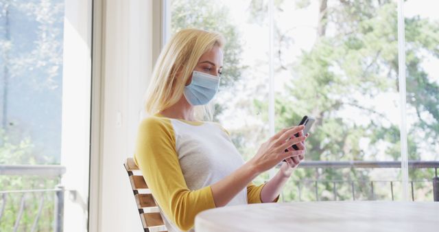 Woman Wearing Face Mask Using Smartphone at Home - Download Free Stock Images Pikwizard.com