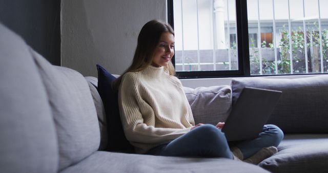 Young Woman Relaxing on Sofa with Laptop in Modern Living Room - Download Free Stock Images Pikwizard.com