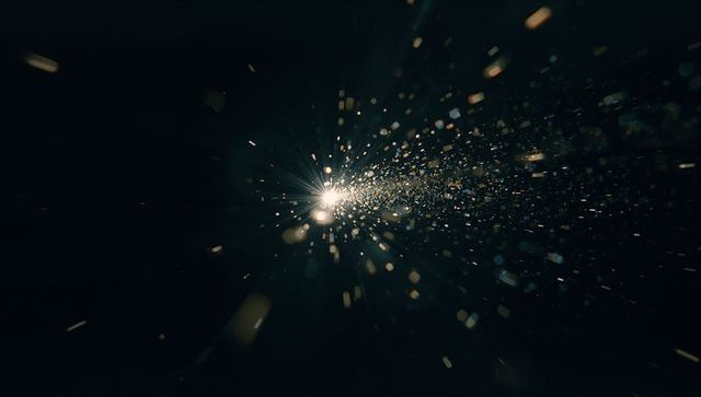 Glowing Particles Radiating from Bright Central Light in Dark Space