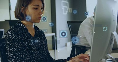 Professional woman analyzing data on computer in modern office
