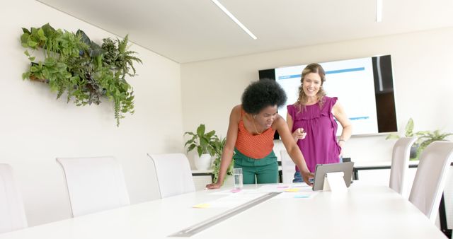 Businesswomen Collaborating in Modern Office with Digital Tablet - Download Free Stock Images Pikwizard.com