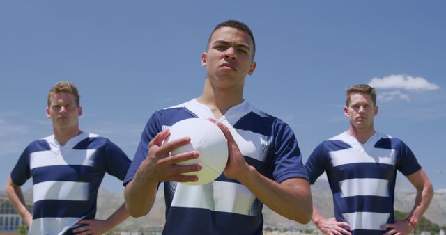 Determined Rugby Players Holding Ball on Field - Download Free Stock Images Pikwizard.com