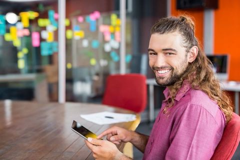 Office professional using tablet in creative workspace