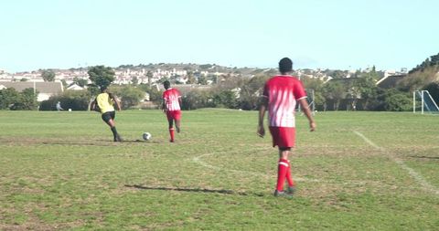 Soccer Players in Action on Sunny Day