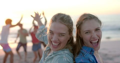 Joyful Young Women Celebrating at Sunny Beach Gathering
