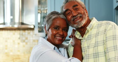Happy Senior Couple Smiling in Modern Kitchen