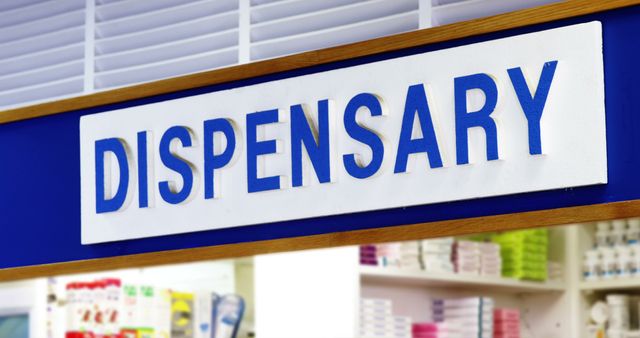 Overhead sign for a dispensary inside a pharmacy store. Highlights medical and healthcare environment. Useful for articles, websites, and marketing materials related to pharmacology, healthcare services, and retail medicine.