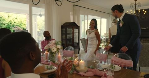 Bride Laughing with Friends at Elegant Wedding Dinner