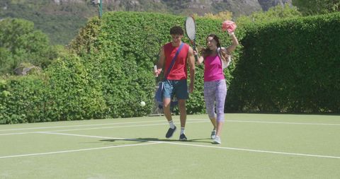 Joyful Couple Enjoying Tennis on Sunny Day