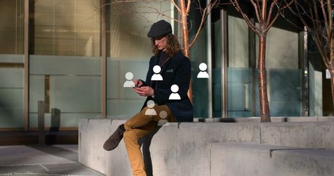 Urban Explorer Browsing Smartphone Wearing Newsboy Cap