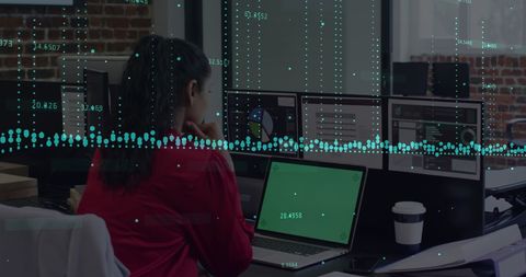 Businesswoman Analyzing Data with Overlaid Graphs on Laptop Screen