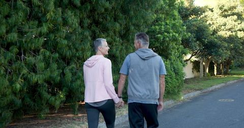 Senior Couple Enjoying Leisurely Walk in Serene Neighborhood