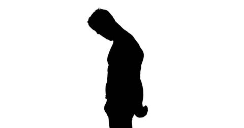 Silhouette of slouched young man in introspection