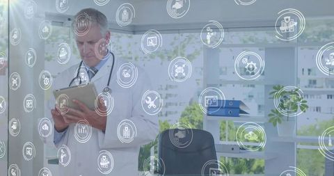 Doctor utilizing digital tablet with medical icons overlay in modern office