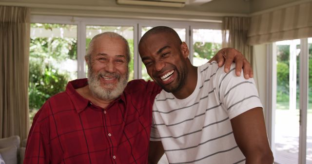Portrait of happy diverse senior father and adult son embracing at home and smiling - Download Free Stock Photos Pikwizard.com