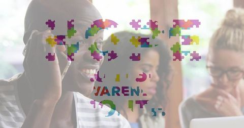 Smiling man calling in shared workspace with colorful jigsaw puzzle overlay for teamwork and product
