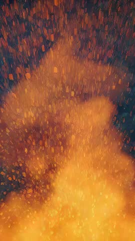 Vertical video of blazing ember column sending sparks and amber glow upward at night