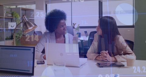 Diverse Business Women Discuss Financial Data in Modern Office