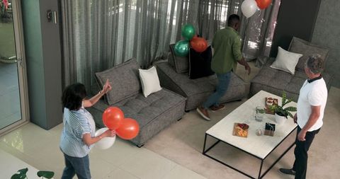 Friends Decorating Room with Balloons for Celebration